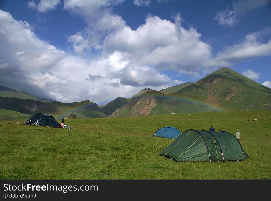 The rainbow in the Caucasian mountains. Summer.