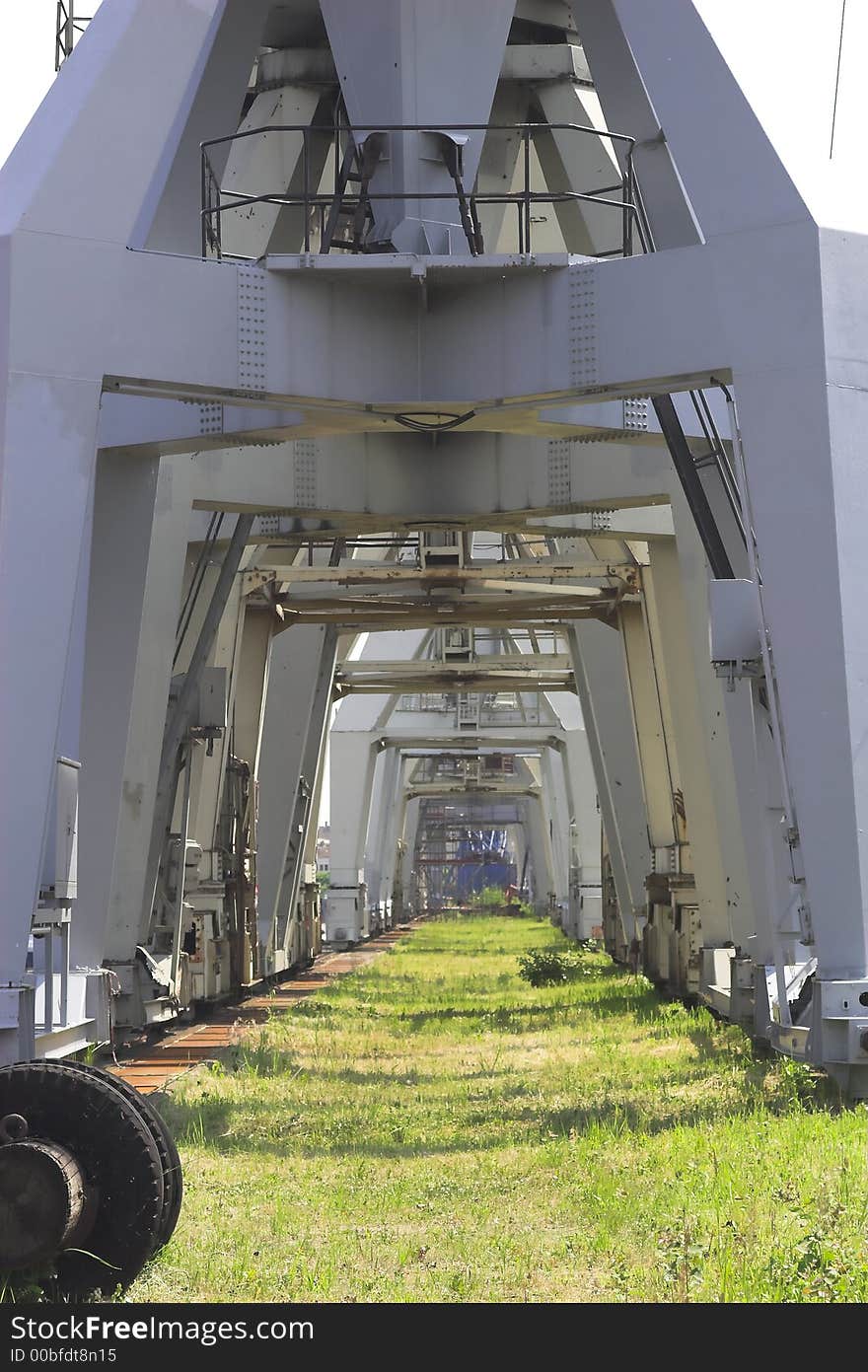 Old cranes with green grass. Old cranes with green grass