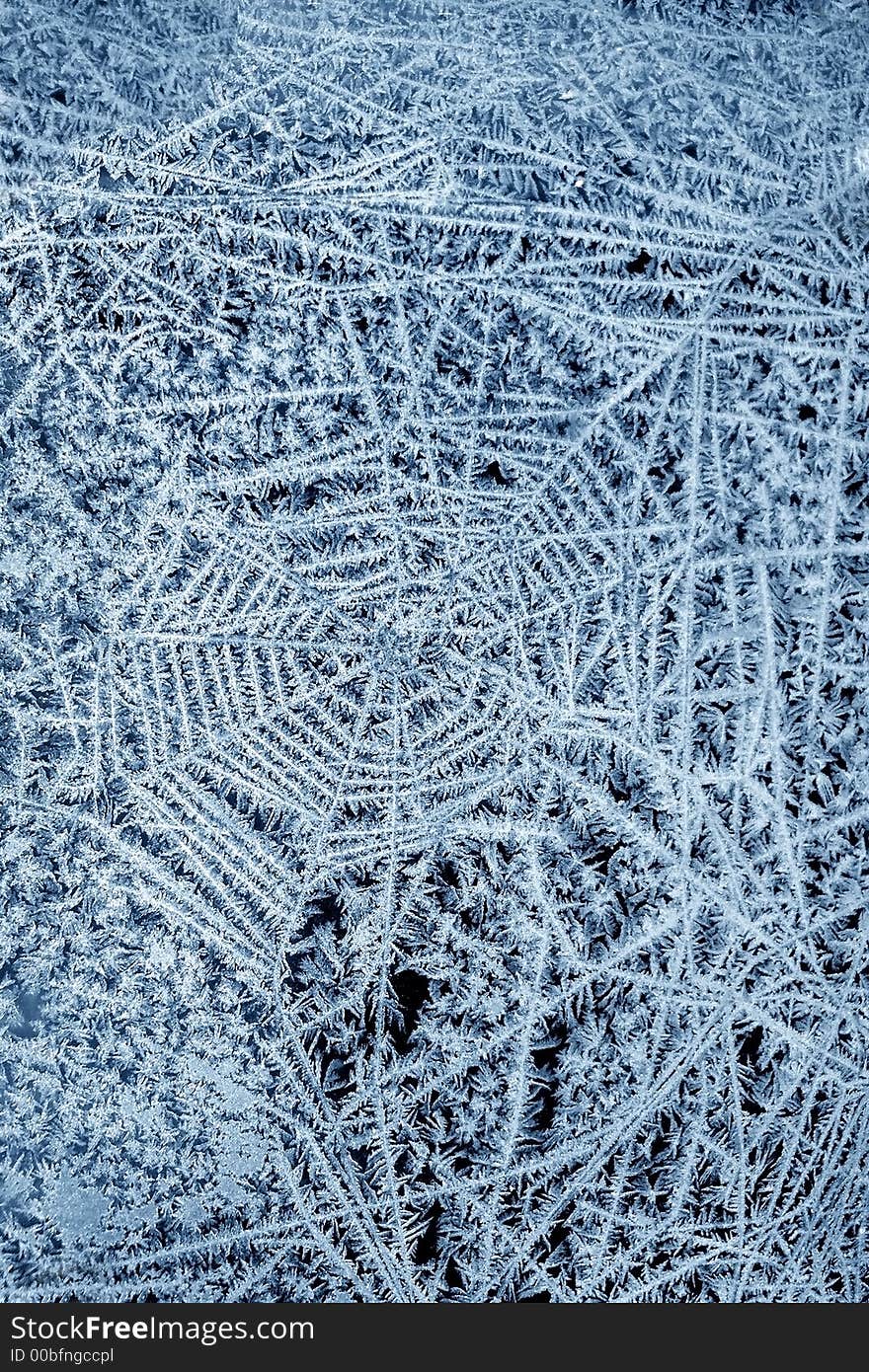 Snowflakes on glass as a spider web