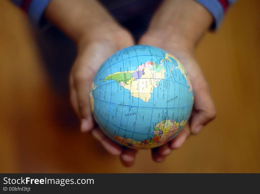 A kid holding a globe in his hands. A kid holding a globe in his hands