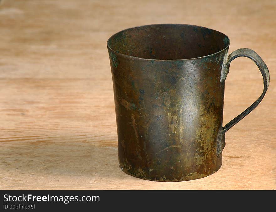 Old  cup from a copper  on a table