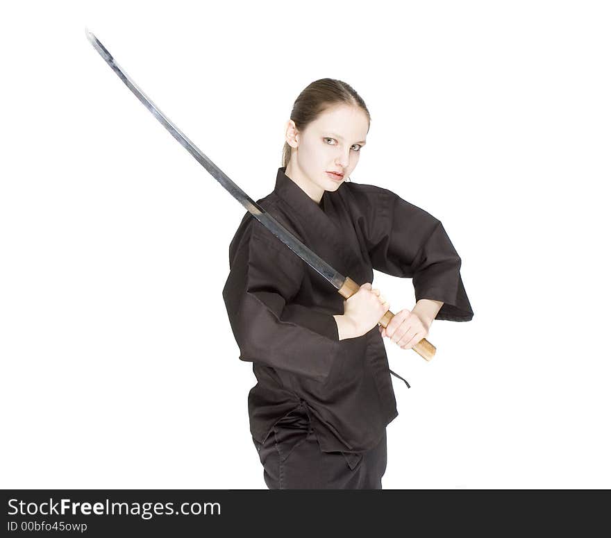 A girl holding and swinging a katana. A girl holding and swinging a katana