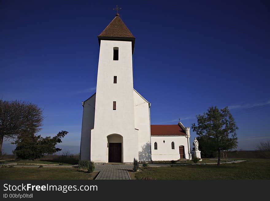 Small villager church with white walls