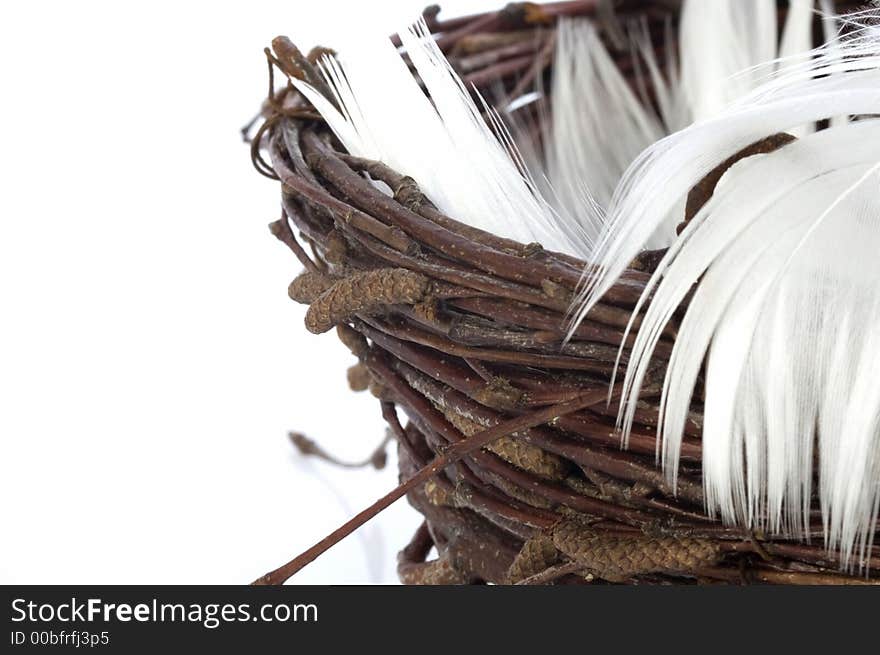 Bird nest with feathers. isolated on the white background