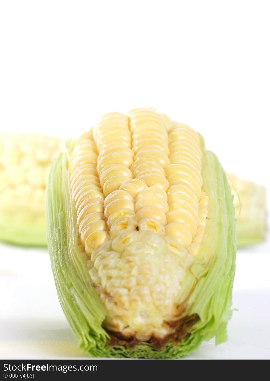 Two yellow and green Fresh corn on the cob ready for roasting