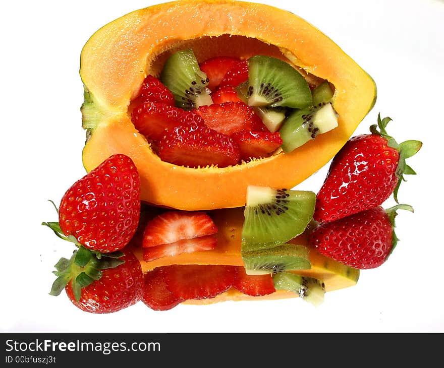 Fresh strawberry and papaya on mirror background with full reflection. Fresh strawberry and papaya on mirror background with full reflection