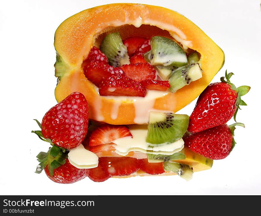 Fresh strawberry and papaya on mirror background with full reflection and cream. Fresh strawberry and papaya on mirror background with full reflection and cream