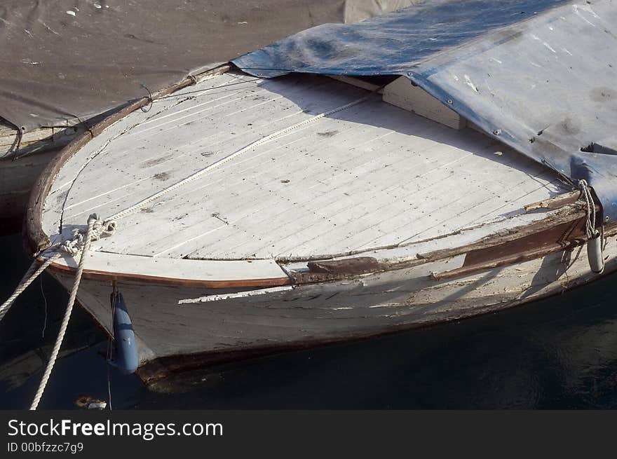 Part of  old wooden boat in small sea port