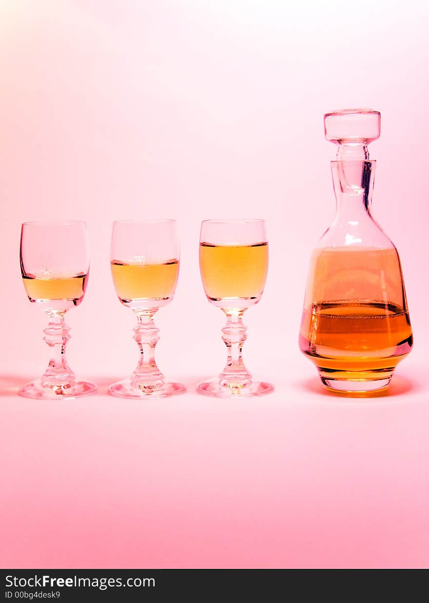 Small liqueur-glasses with a bottle alcohol. Small liqueur-glasses with a bottle alcohol