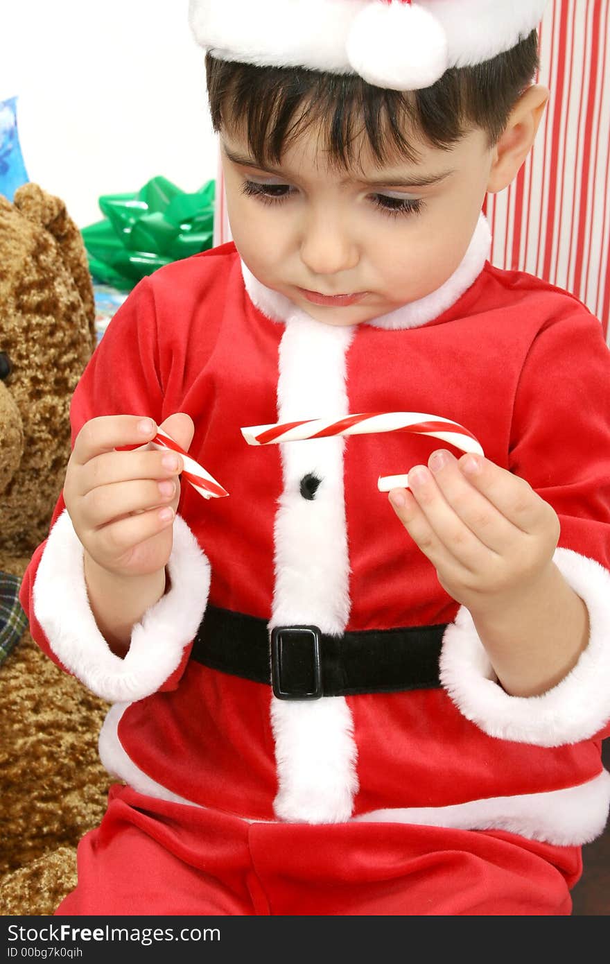 Sad boy in Christmas Suit with broken candy can in hand. Sad boy in Christmas Suit with broken candy can in hand.