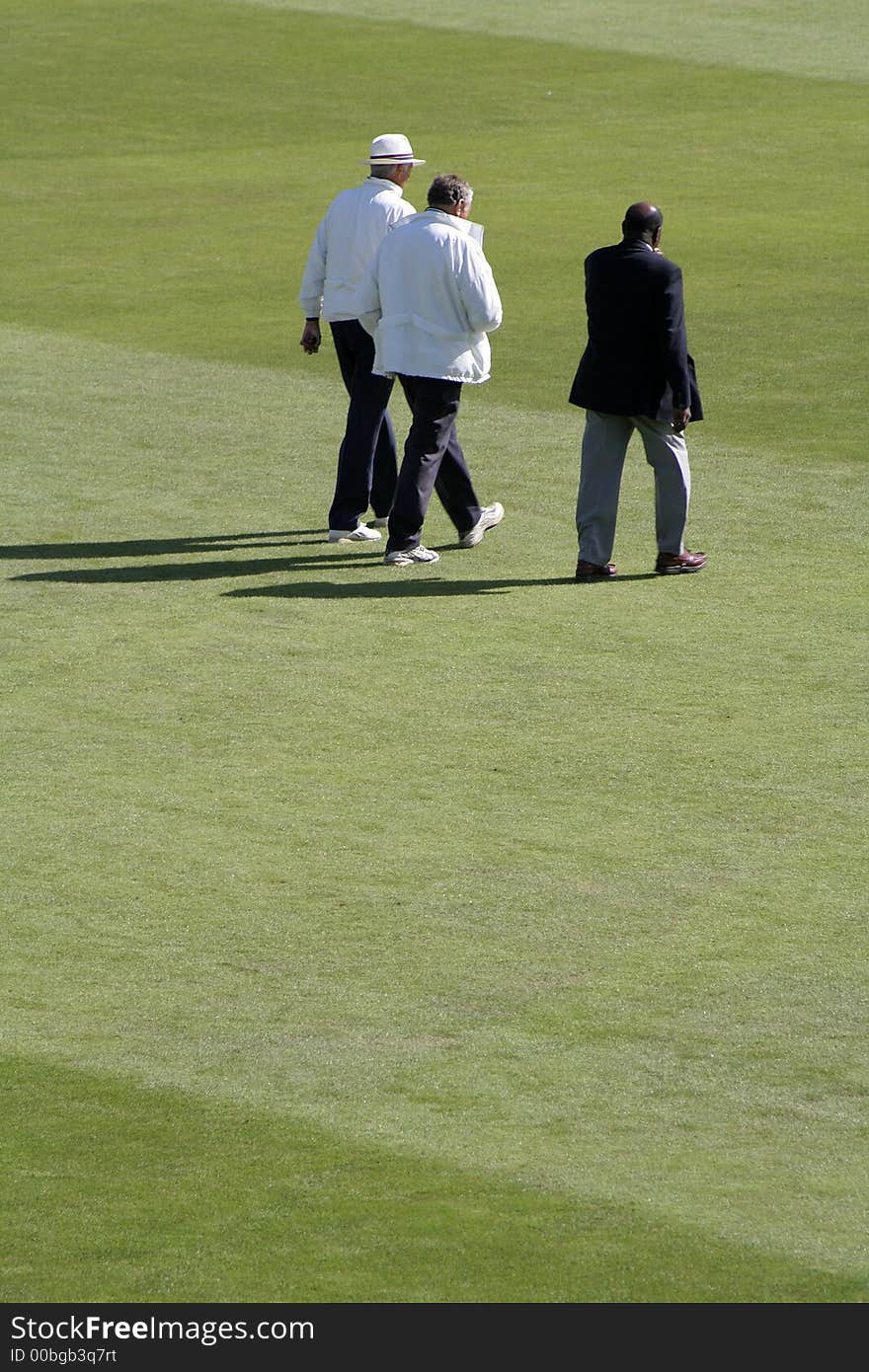 Umpires and official walk out to the square to inspect the pitch. Umpires and official walk out to the square to inspect the pitch