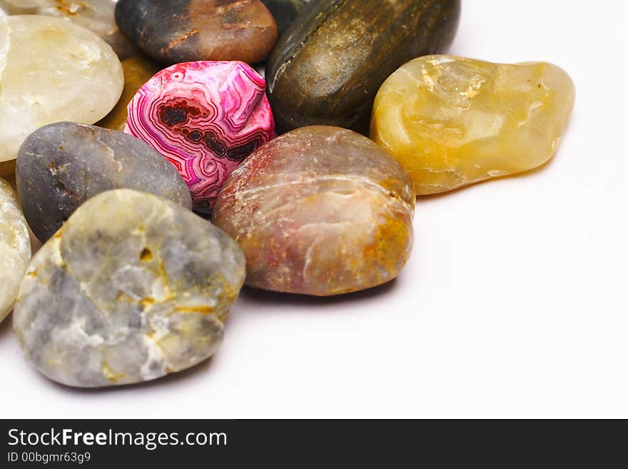 Picture of a red polished stone in a pile of plain stones. Picture of a red polished stone in a pile of plain stones