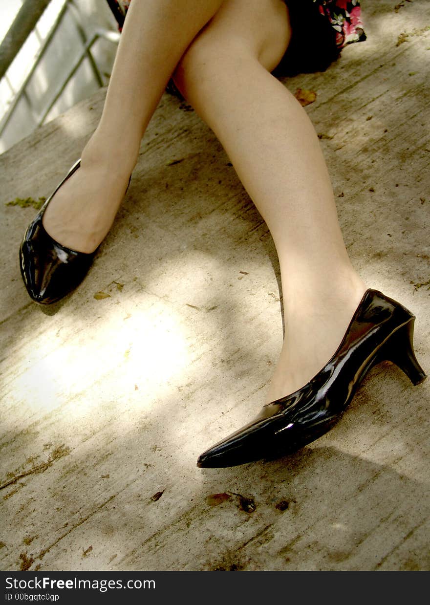 Shiny black heels on legs. Shiny black heels on legs