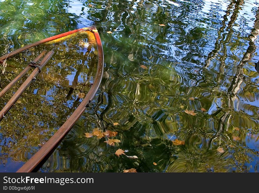 Boat drowned in a canal, covered with autumn leaves. Boat drowned in a canal, covered with autumn leaves