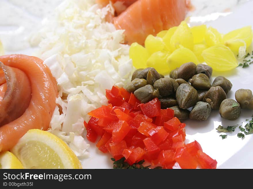 Slices of fresh kipper on the plate with  vegetables