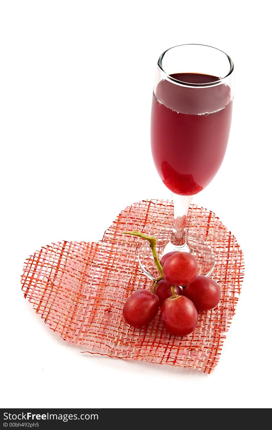 Glass of red wine on a background of heart