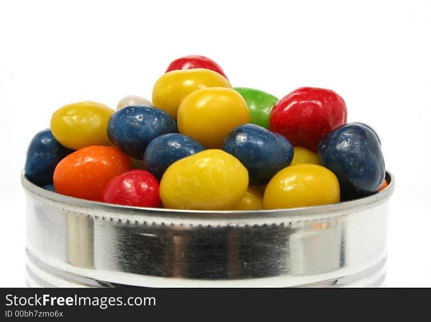 Multi-coloured sweets with raisin in metal bank 2, isolated on white, (look similar images in my portfolio)