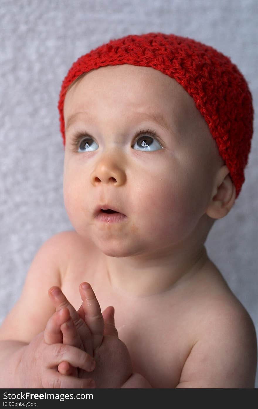 Portrait of 9-month old baby wearing a red cap. Portrait of 9-month old baby wearing a red cap