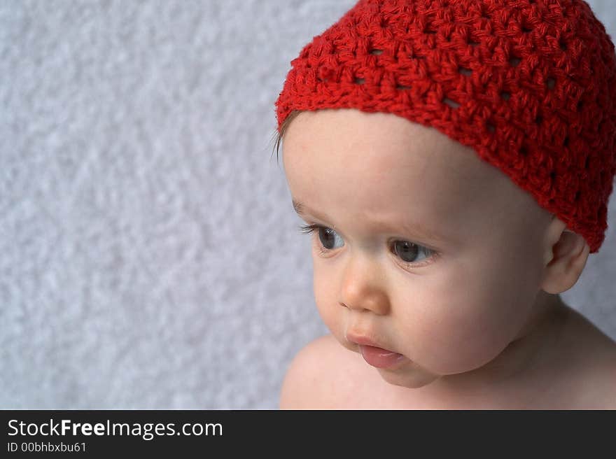 Portrait of 9-month old baby wearing a red cap. Portrait of 9-month old baby wearing a red cap