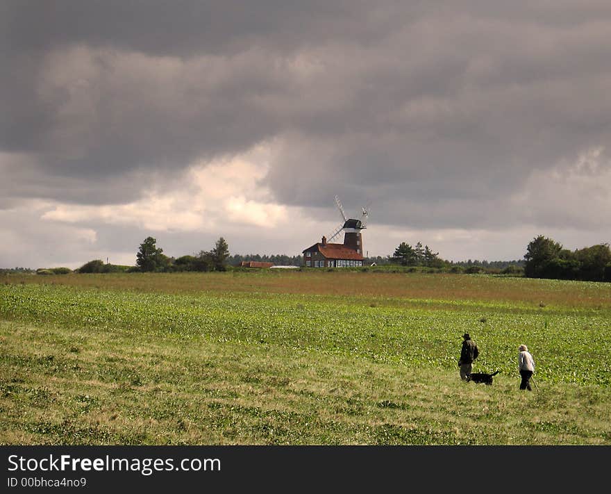 Elderly Couple Walking The Dog England