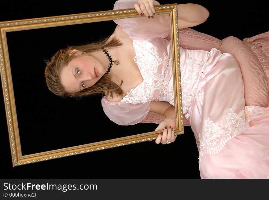 Portrait of a girl in a victorian dress and necklace holding a gold picture frame. Portrait of a girl in a victorian dress and necklace holding a gold picture frame