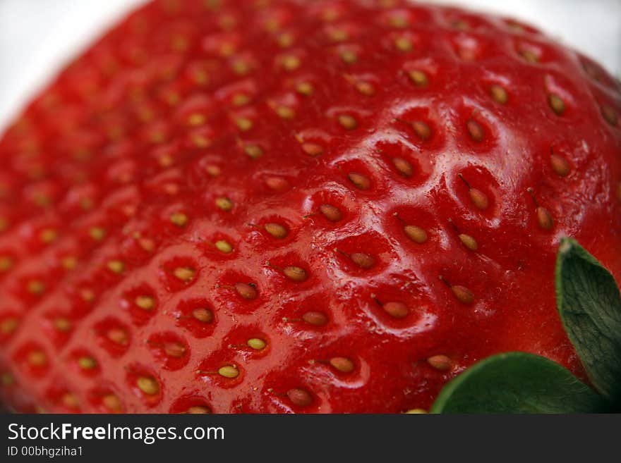 A single strawberry fruit on the background