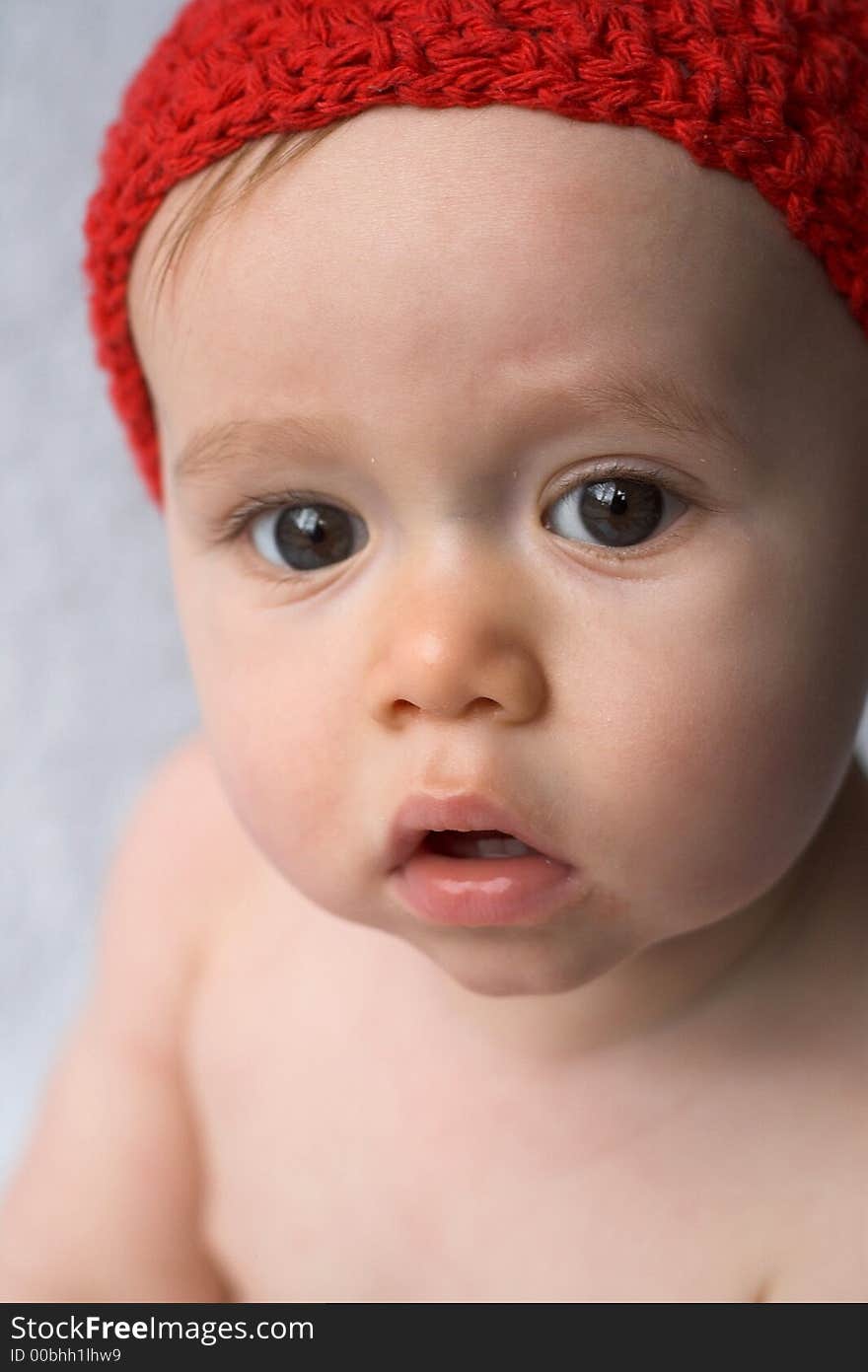 Portrait of 9-month old baby wearing a red cap. Portrait of 9-month old baby wearing a red cap