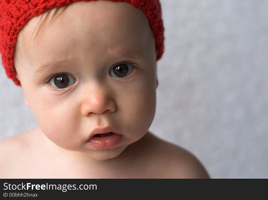 Portrait of 9-month old baby wearing a red cap. Portrait of 9-month old baby wearing a red cap