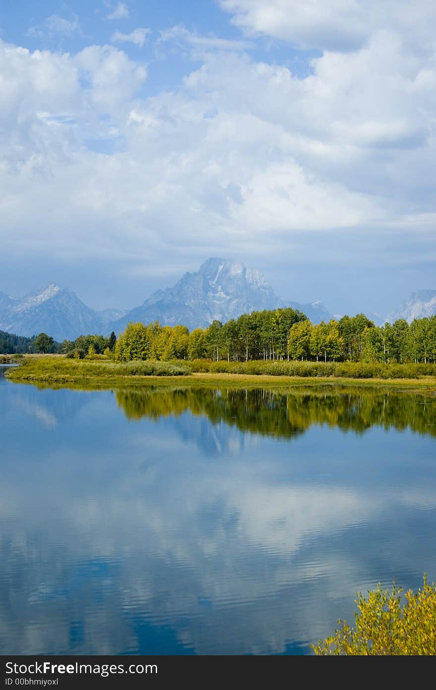 The reflection of the sky and mountains on a lake in Grand Teton National Park. The reflection of the sky and mountains on a lake in Grand Teton National Park