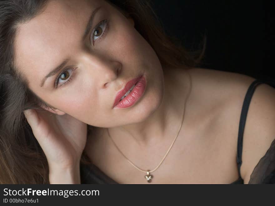 Beautiful brunette portrait over dark background. Beautiful brunette portrait over dark background