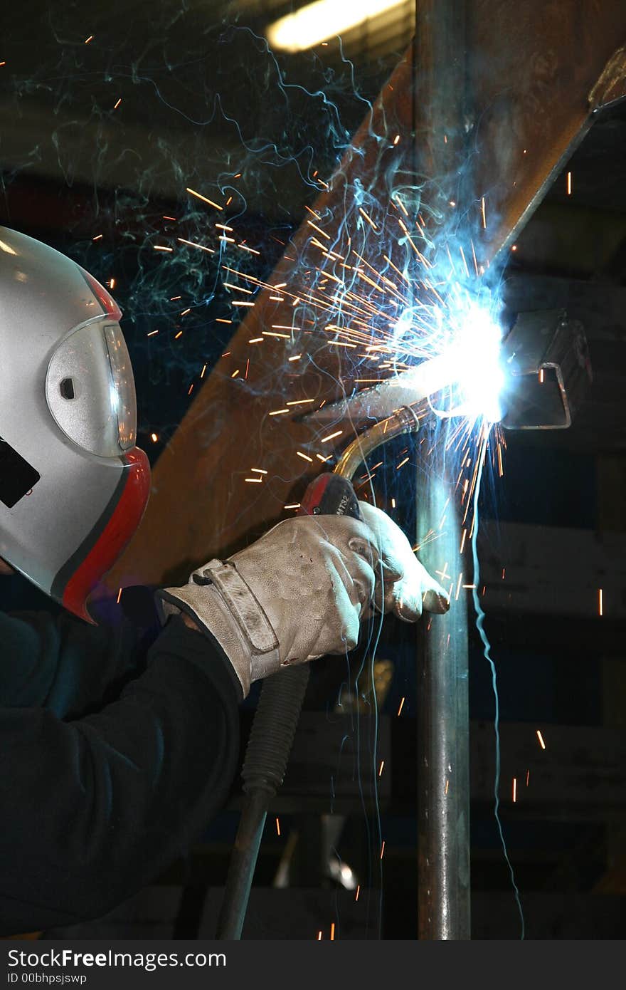 Worker welding steel in a workshop