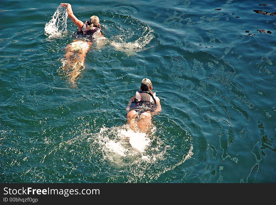 Two girls swimming by in Lake Washington, Seattle. Two girls swimming by in Lake Washington, Seattle