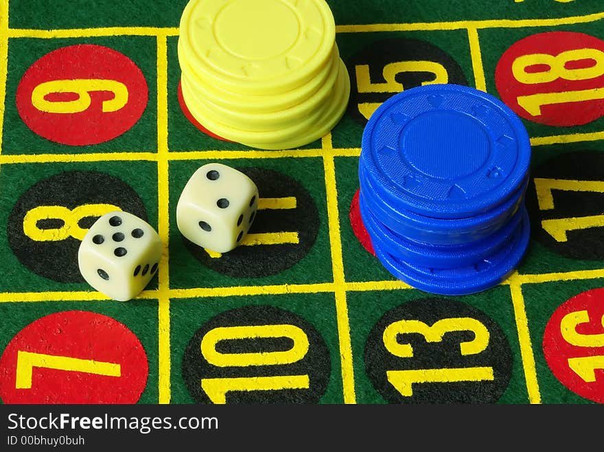 Casino still life. Dice, numbers, blue and yellow chips background. Casino still life. Dice, numbers, blue and yellow chips background.