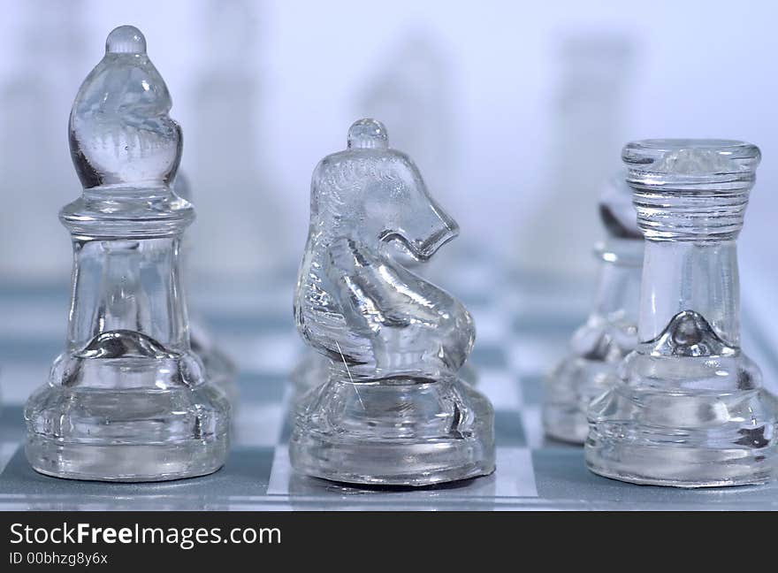 Three figures of a glass chess game