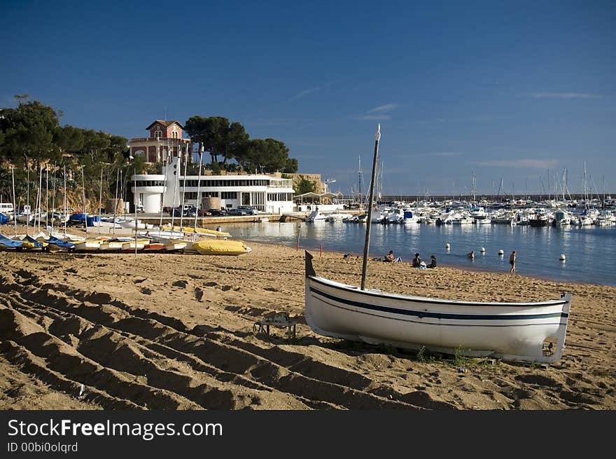 Port in Spain, beach scenery, blue sky, fisher boats lying on the shore. Port in Spain, beach scenery, blue sky, fisher boats lying on the shore