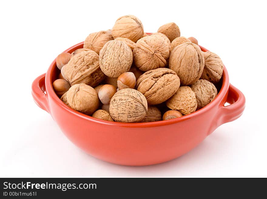 Red bowl with mixed nuts, walnuts, hazelnuts, almonds