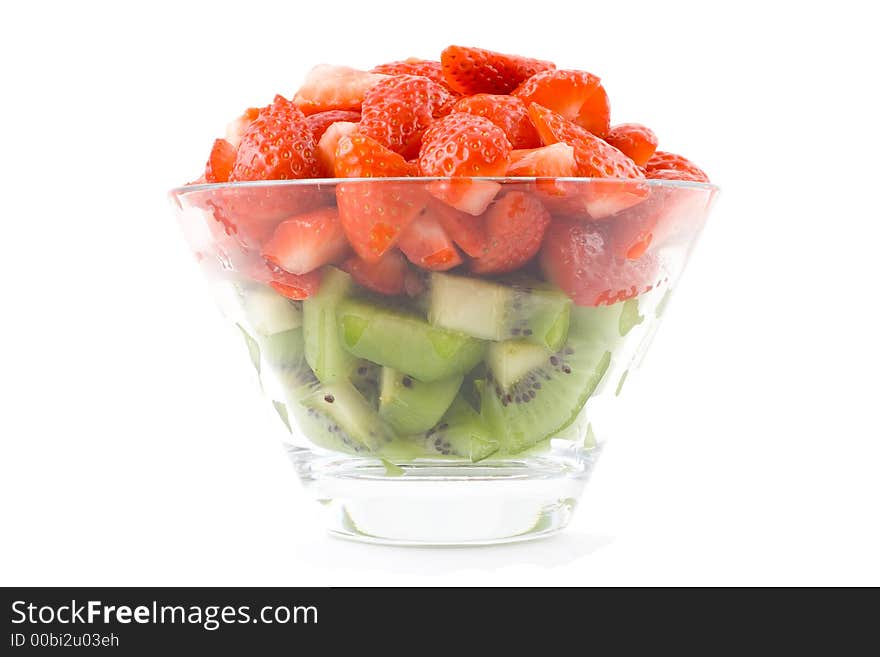 Green and red - kiwi and strawberries in small transparent bowl. Isolated. On white background