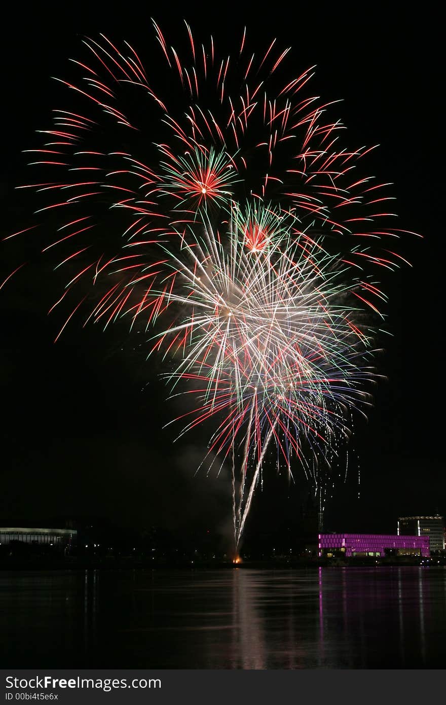 Fireworks in Linz (Austria) at the Danube river with beautiful reflections. On the right side the Brucknerhaus (orchestra house) on the left the Lentos (Museum) with its illuminated walls. Fireworks in Linz (Austria) at the Danube river with beautiful reflections. On the right side the Brucknerhaus (orchestra house) on the left the Lentos (Museum) with its illuminated walls.