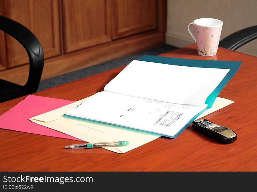 Board room table with files and a cup of coffee. Board room table with files and a cup of coffee