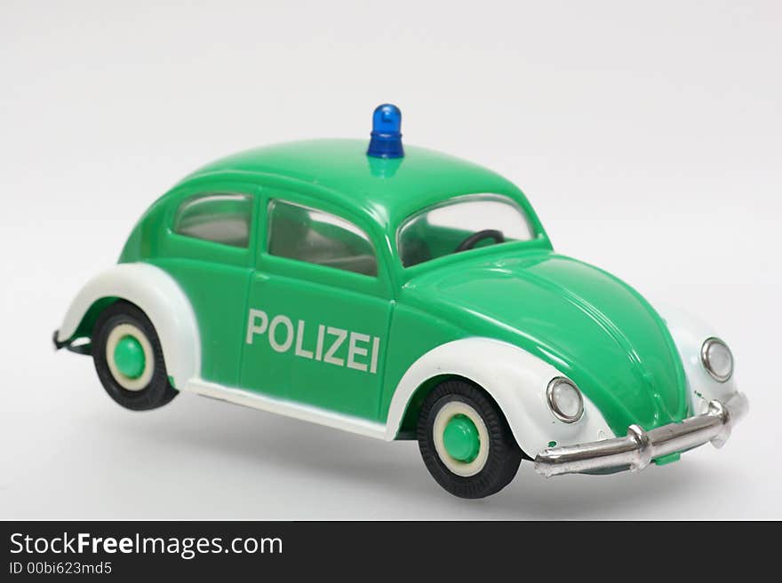 Old plastic police car. German police VW Beatle like Germany used to have in the 70's. One of the many thousand toys my brother is collecting. Toy is from the 70's or 80's. Old plastic police car. German police VW Beatle like Germany used to have in the 70's. One of the many thousand toys my brother is collecting. Toy is from the 70's or 80's.