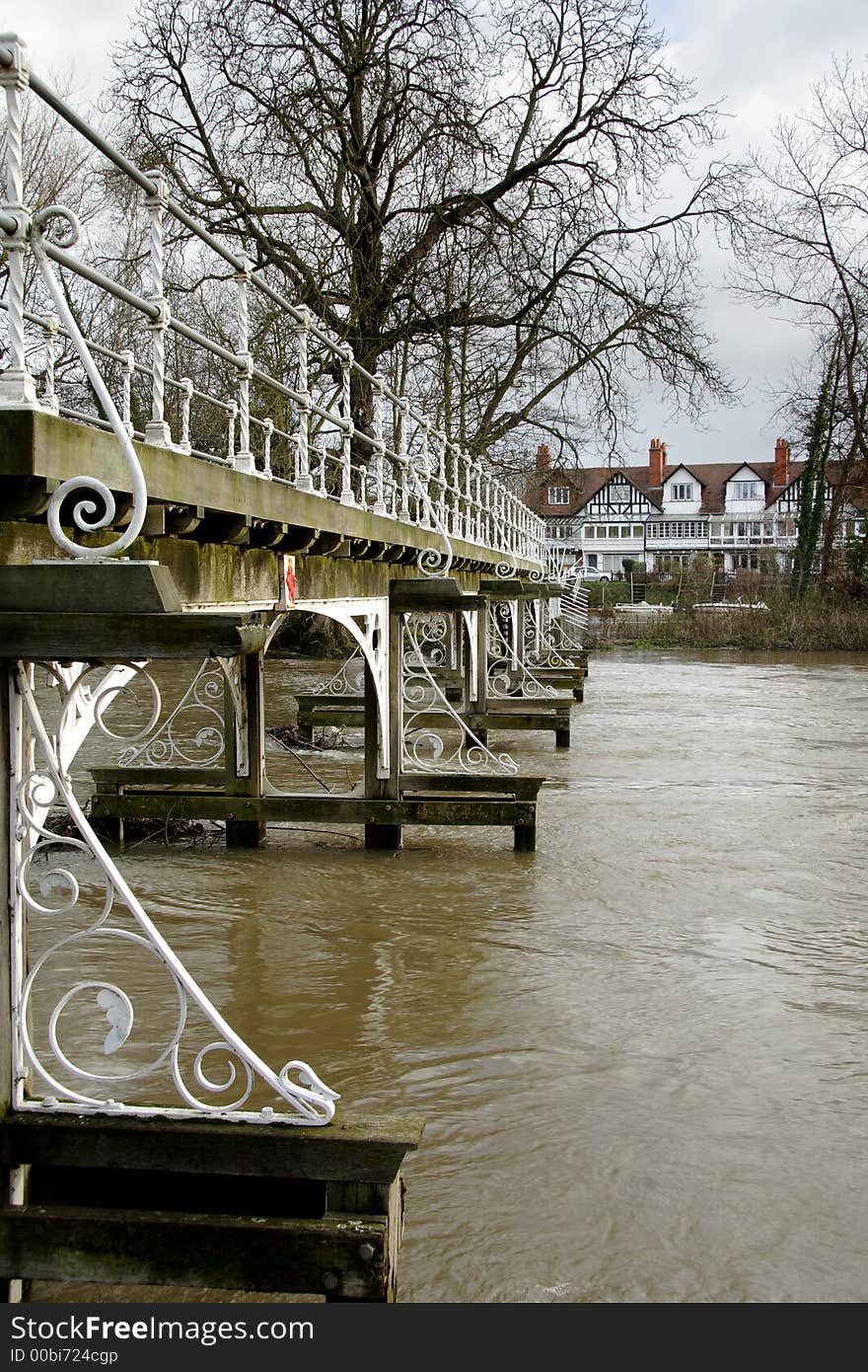 Victorian Footbridge over a Swollen River Thames in Winter