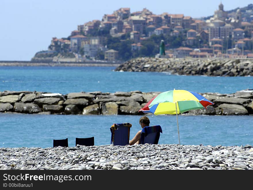 Beach scenery, a couple is sitting at the beach. Beach scenery, a couple is sitting at the beach