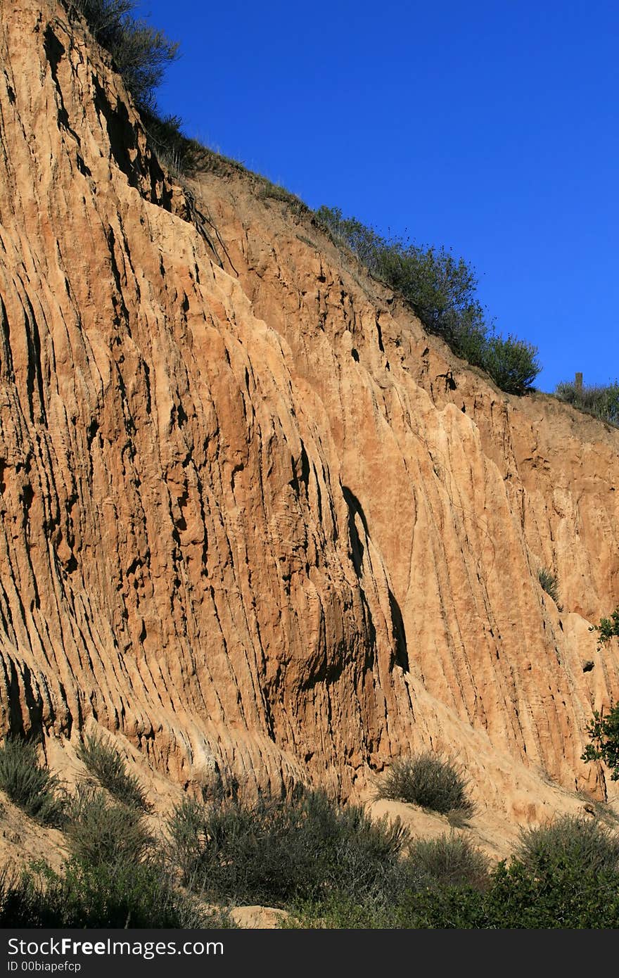 Orange colored dirt cliffs in California. Orange colored dirt cliffs in California