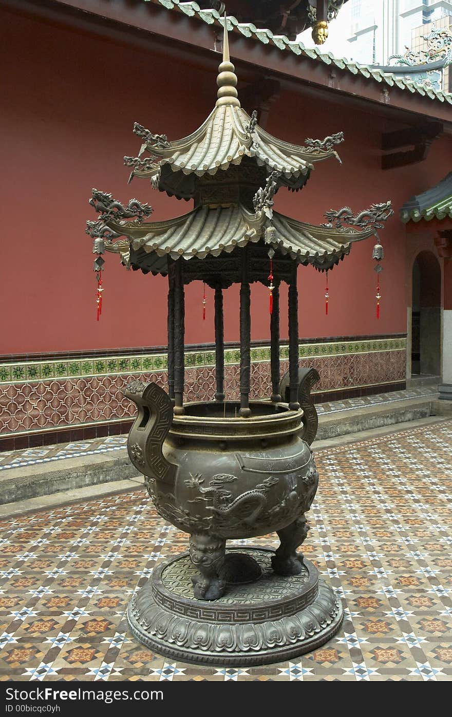 Joss-stick burner in the rear courtyard of a Chinese temple in Singapore. Joss-stick burner in the rear courtyard of a Chinese temple in Singapore