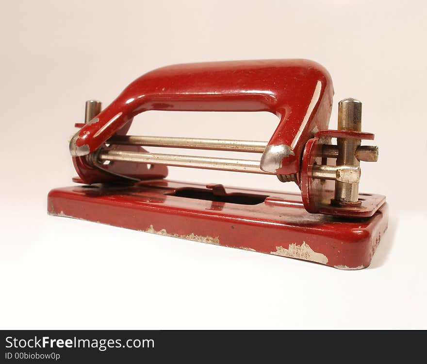 Red vintage metal puncher looks used and really old