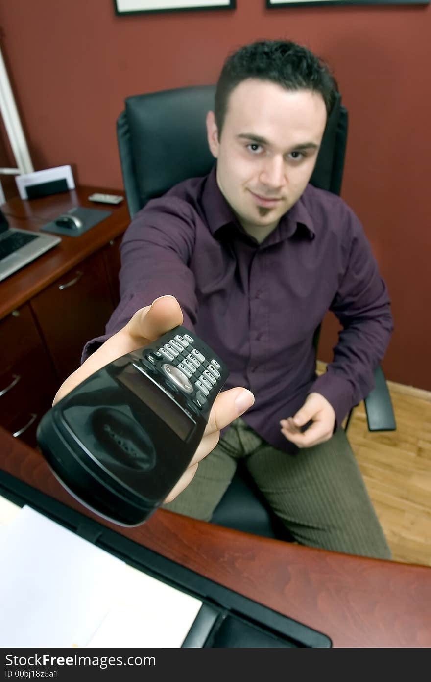 Businessman in office with phone