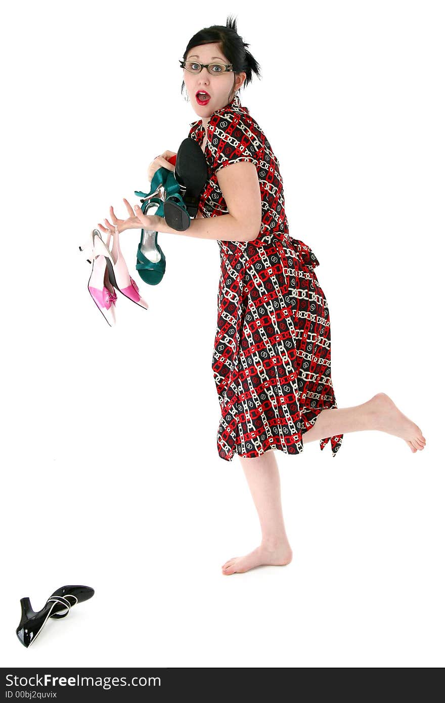 Woman barefoot running with arm full of shoes.  Full body over white. Woman barefoot running with arm full of shoes.  Full body over white.