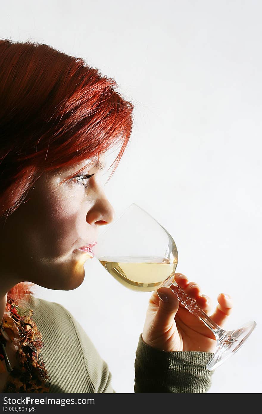 The beautiful woman with a glass of white wine. The beautiful woman with a glass of white wine