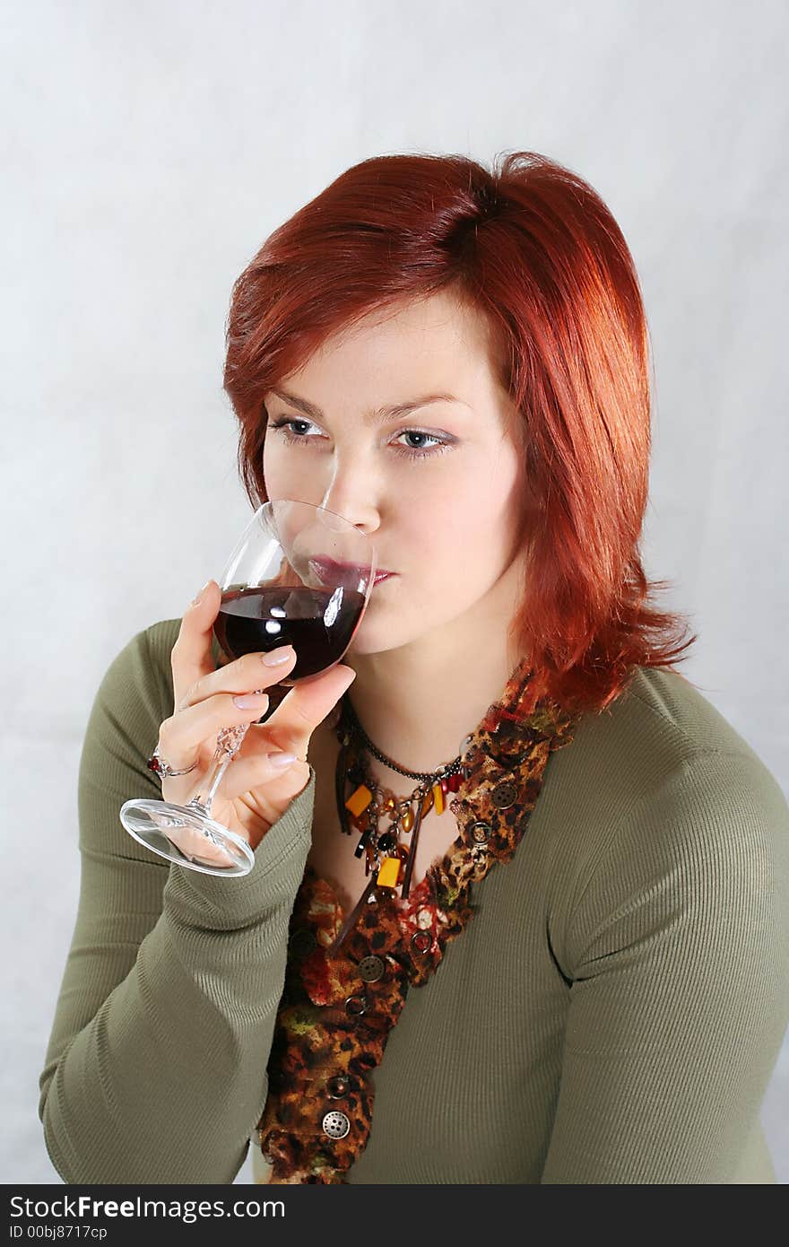 The beautiful woman with a glass of red wine. The beautiful woman with a glass of red wine