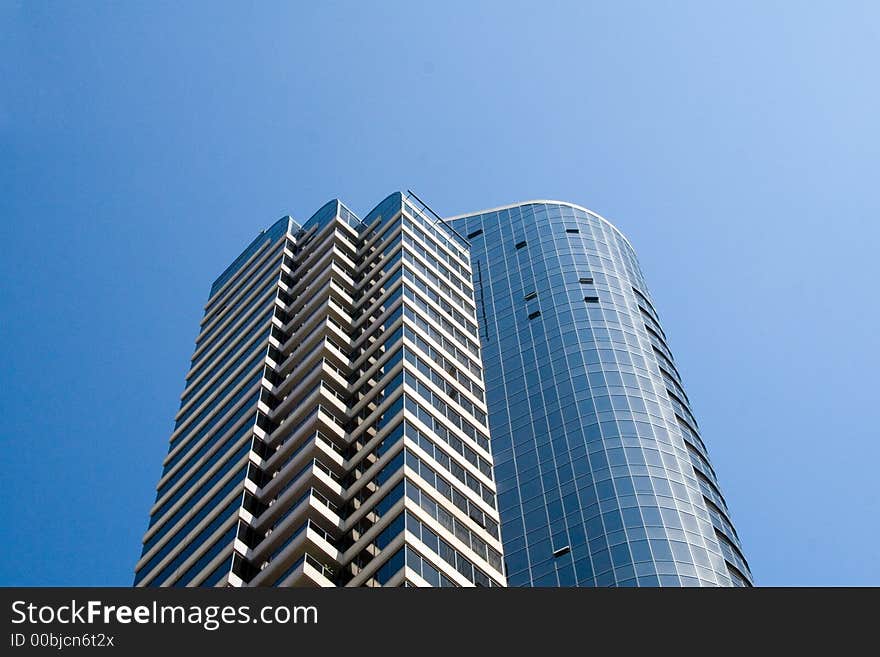 Modern skyscrapers against a bright blue sky